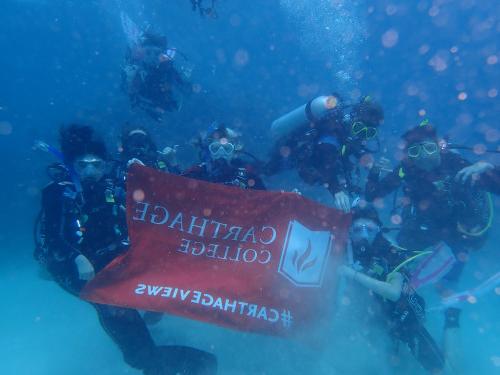 My dive group and I taking an underwater photo with the Carthage flag.